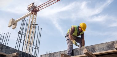 Worker At Construction Site Is Fixing The Form For The Beam